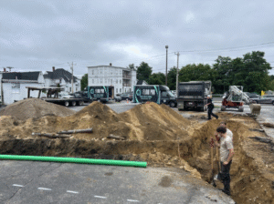 plumbing pipe repair featuring Flow Pro Plumber assessing the ground where a large sewer pipe will be placed