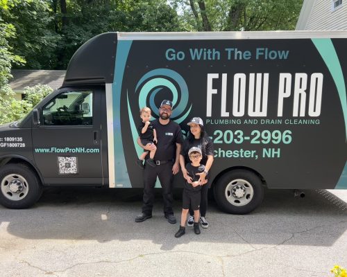 Flow Pro Plumbing and Drain Cleaning team standing in front of company service truck, trusted plumber Manchester NH providing professional plumbing and drain cleaning services.
