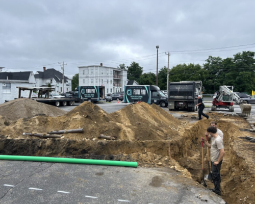 plumbing pipe repair featuring Flow Pro Plumber assessing the ground where a large sewer pipe will be placed
